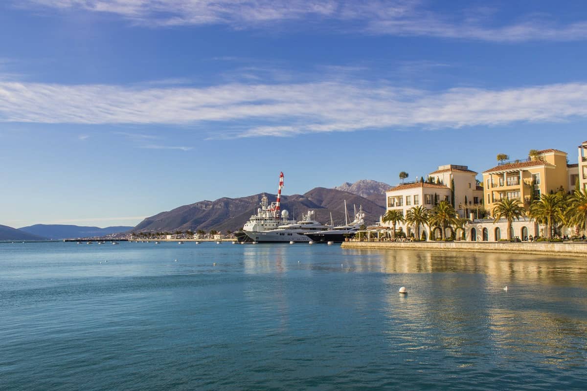 Porto Montenegro Marina with yachts and boats in front of Al Posto Giusto restaurant and Regent Hotel. Berths available for different positions.